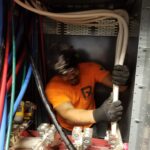 An electrician holding thick wiring