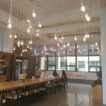 A big dining area with hanging light bulbs