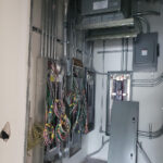 Four electrical panels with exposed wires