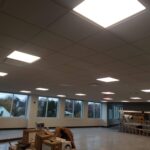 A big office space with square ceiling lighting